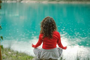 Mujer meditando en un espacio natural.